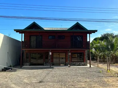 a large wooden building sitting on top of a road at Seahorse Breeze Apartment 2 in Uvita