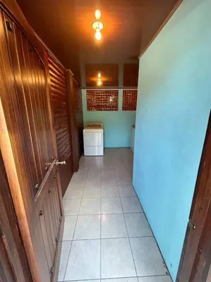 a hallway of a bathroom with a toilet and a door at Seahorse Breeze Apartment 2 in Uvita