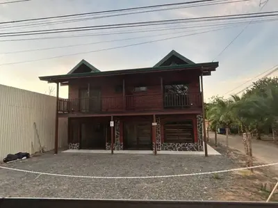 a large wooden house with a balcony at Seahorse Breeze Apartment 2 in Uvita