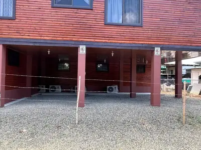 a building with two dogs sitting inside of it at Seahorse Breeze Apartment 2 in Uvita