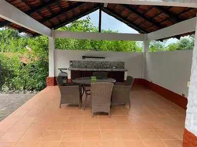 an outdoor patio with a table and chairs at Villa Lagunillas in Lagunillas