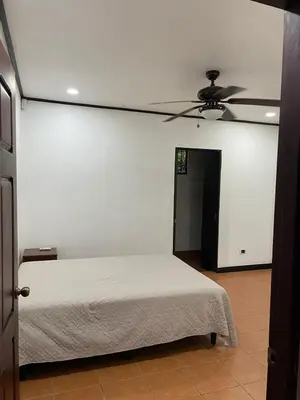 a bedroom with a bed and a ceiling fan at Villa Lagunillas in Lagunillas