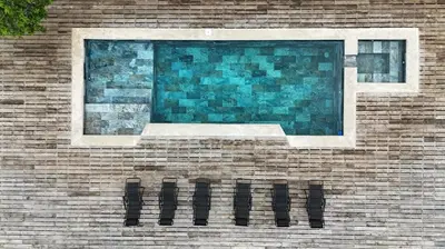 a window on a brick wall with a reflection of a window at Tierra Vital Atenas Villa 2 in Atenas