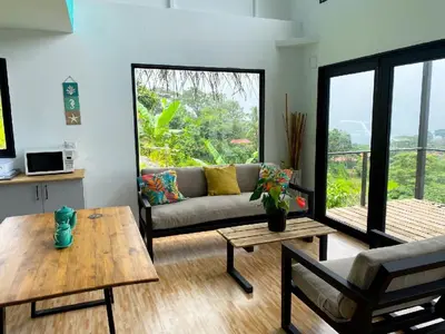 a living room with a couch and a table at Tierra Vital Atenas Villa 2 in Atenas