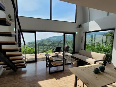 a living room with a couch and a table at Tierra Vital Atenas Villa 2 in Atenas