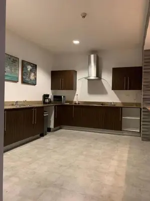 a large kitchen with wooden cabinets and a hood at Spacious and Modern Penthouse Condo in Jacó