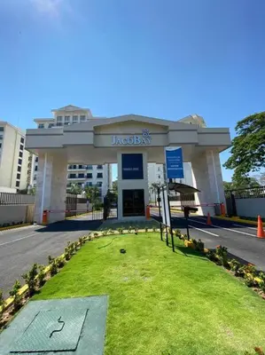 a building with a sign in the grass in front of it at Spacious and Modern Penthouse Condo in Jacó