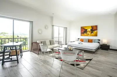a living room with a couch and a table at Spacious and Modern Penthouse Condo in Jacó