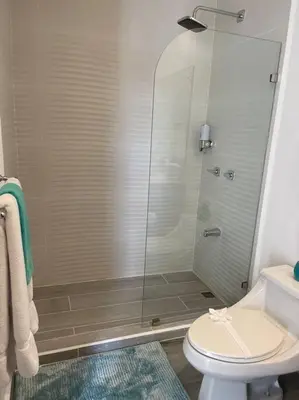 a bathroom with a shower and a toilet at Spacious and Modern Penthouse Condo in Jacó