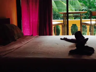 a person laying on a bed in a room at BEACH OPEN-FLAT with TERRACE ANALIA in Manuel Antonio
