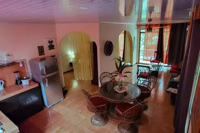 a living room with a table and a kitchen at BEACH OPEN-FLAT with TERRACE ANALIA in Manuel Antonio