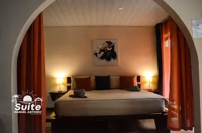 a bedroom with a bed in a room with two lamps at BEACH OPEN-FLAT with TERRACE ANALIA in Manuel Antonio