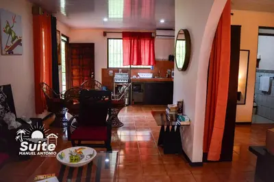 a living room with a table and a kitchen at BEACH OPEN-FLAT with TERRACE ANALIA in Manuel Antonio