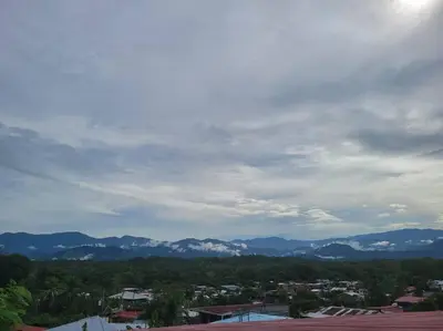 a view of a city with mountains in the distance at Local secret apartament Blue Mountain in Quepos in Quepos