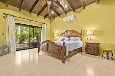 a bedroom with a bed and a large window at Casa Paulina in Playa Conchal