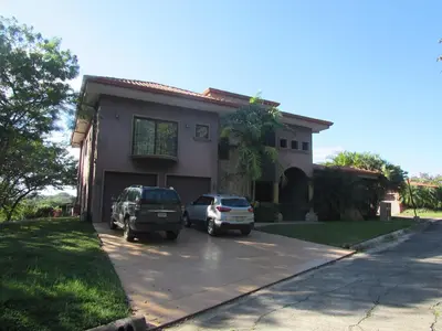 two cars parked in front of a house at Casa Paulina in Playa Conchal
