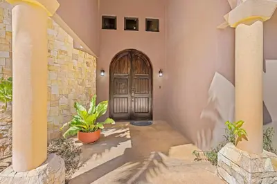 a front door of a house with two potted plants at Casa Paulina in Playa Conchal