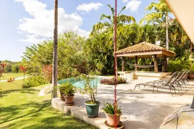 a backyard with a swimming pool and a gazebo at Casa Paulina in Playa Conchal