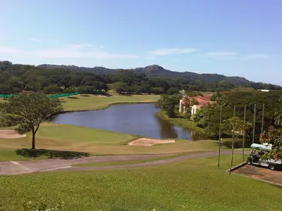 a view of a golf course with a lake at Casa Paulina in Playa Conchal
