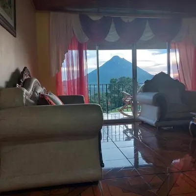 a living room with a couch and a view of a mountain at Villa Esperanza El Castillo in Fortuna