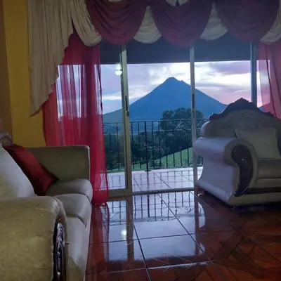 a living room with a view of a mountain at Villa Esperanza El Castillo in Fortuna