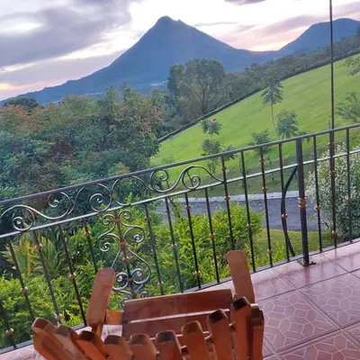 a balcony with chairs and a view of a mountain at Villa Esperanza El Castillo in Fortuna