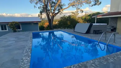 a swimming pool in the backyard of a house at Casa Marigold in Coyol