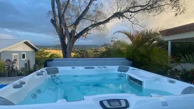 a hot tub in the backyard of a house at Casa Marigold in Coyol