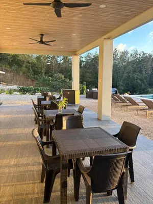 a row of tables and chairs on a patio at Ocean View Villa at Solindo Stays in Marbella
