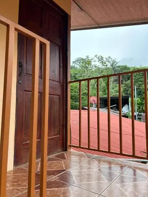 an open door of a porch with a deck at Cabinas Paraíso in Dominical