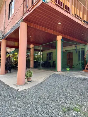 an outside view of a building with pink columns at Cabinas Paraíso in Dominical