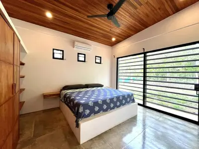 a bedroom with a bed and a ceiling fan at 3 Bdr Villa With Pool , Near beach, Fast Wifi in Veintisiete de Abril