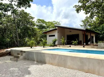 a house with a swimming pool in front of it at 3 Bdr Villa With Pool , Near beach, Fast Wifi in Veintisiete de Abril