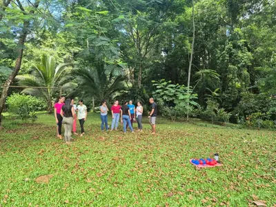 a group of people standing in a field flying a kite at Haciendo Amigos en el Canasto in San Isidro
