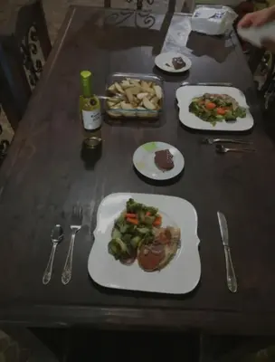 a table with plates of food and forks and spoons at Haciendo Amigos en el Canasto in San Isidro