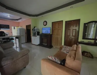 a living room with two couches and a kitchen at Haciendo Amigos en el Canasto in San Isidro