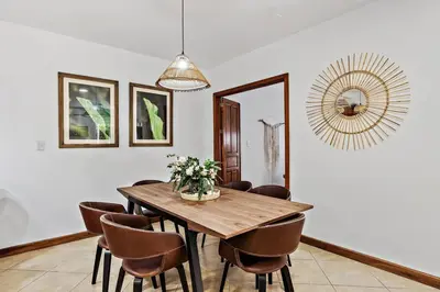 a dining room with a wooden table and chairs at BLA1 3 Bedroom Condo with Direct Beach Access in Tamarindo