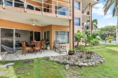 a house with a patio with a table and chairs at BLA1 3 Bedroom Condo with Direct Beach Access in Tamarindo