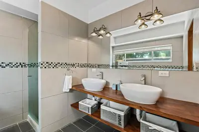 a bathroom with two sinks and a mirror at BLA1 3 Bedroom Condo with Direct Beach Access in Tamarindo
