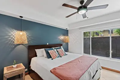 a bedroom with a bed with a ceiling fan and a window at BLA1 3 Bedroom Condo with Direct Beach Access in Tamarindo