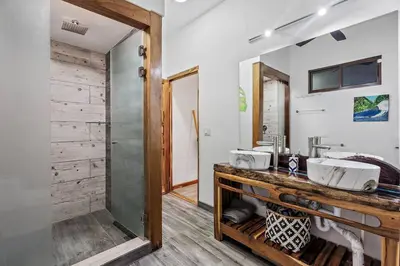 a bathroom with two sinks and a mirror at Casa Indy 3bdrm Home with Pool in Town Centre in Tamarindo