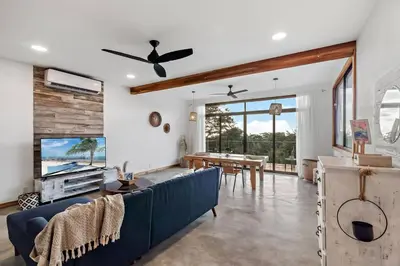 a living room with a blue couch and a table at Casa Indy 3bdrm Home with Pool in Town Centre in Tamarindo