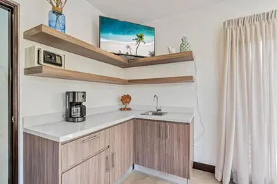 a small kitchen with a sink and a microwave at CU15 New Modern Home with Casitas and Private Pool in Tamarindo