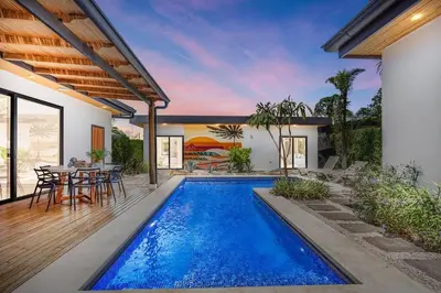 a swimming pool in the backyard of a house at CU15 New Modern Home with Casitas and Private Pool in Tamarindo