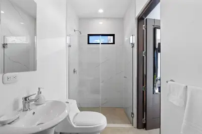 a white bathroom with a shower and a sink at CU19 New 3 Bdrm Mod Home with Casita Prv Pool in Villarreal