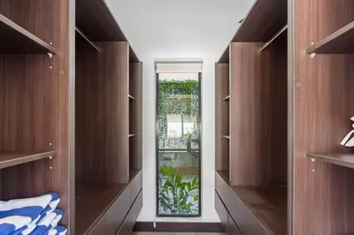 a walk in closet with wooden shelves and a window at CU19 New 3 Bdrm Mod Home with Casita Prv Pool in Villarreal