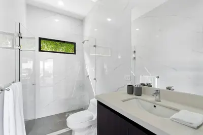 a white bathroom with a toilet and a sink at CU19 New 3 Bdrm Mod Home with Casita Prv Pool in Villarreal