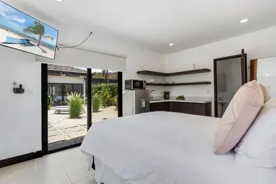 a bedroom with a white bed and a large window at CU19 New 3 Bdrm Mod Home with Casita Prv Pool in Villarreal