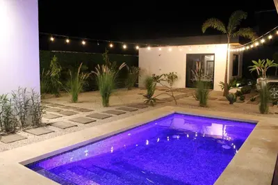 a swimming pool with purple lights in a yard at CU19 New 3 Bdrm Mod Home with Casita Prv Pool in Villarreal