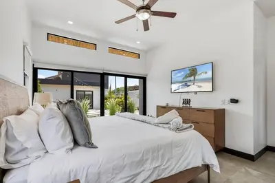 a bedroom with a white bed with a ceiling fan at CU19 New 3 Bdrm Mod Home with Casita Prv Pool in Villarreal